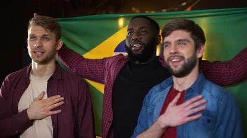 Three Young Adults Singing With Brazil Flag
