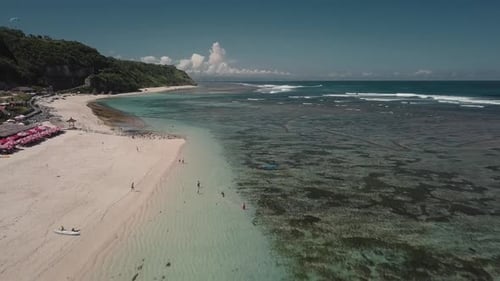 Aerial View of Tropical Beach with Azure Blue Water and Foaming Ocean Waves