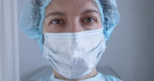 Surgeon Wearing Mask and Cap Close Up