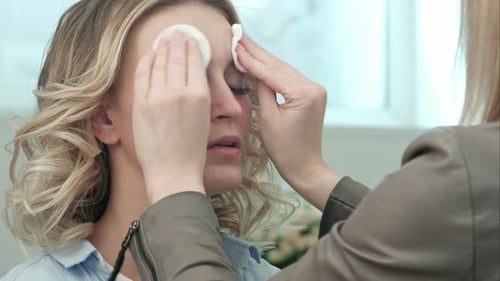 Make-up Artist Preparing and Cleaning Skin of Young Blond Model