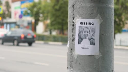 Missing Person Flyer on City Street