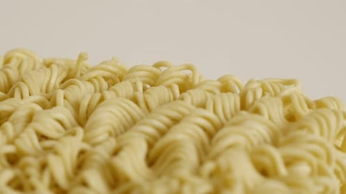 Chinese noodles surface close-up 4K 2160p 30fps UltraHD tilting footage - Instant food block ready