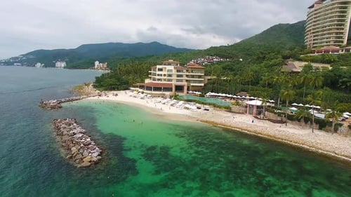 Aerial View of Tropical Beachfront Resort and Turquoise Ocean