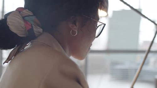 Beautiful Black Businesswoman Smiling and Working at Office Desk