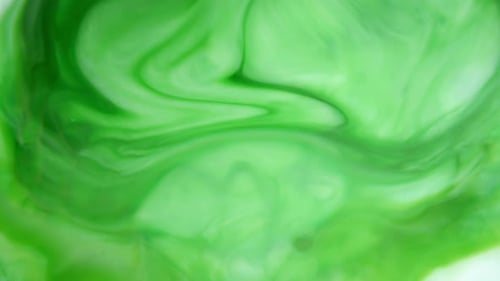 Footage. Ink in Water. Green Ink Reacting in Water Creating Abstract Background.
