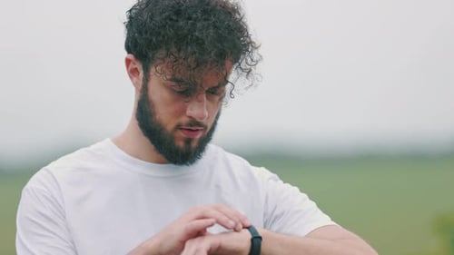 Man Uses Fitness Tracker Watch Outdoors