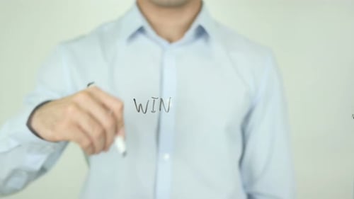 Man Writes "WIN" on Transparent Surface