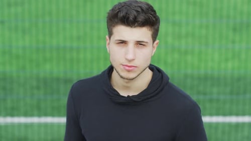 Young Adult Man Close-Up Portrait on Field