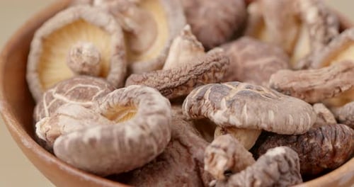 Pile of Dried Shiitake Mushrooms in Wooden Bowl