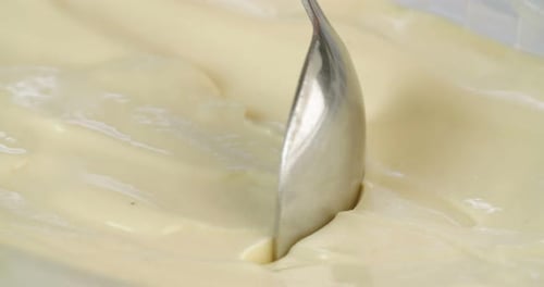 Macro slow motion of mango sorbet ice cream with scoop