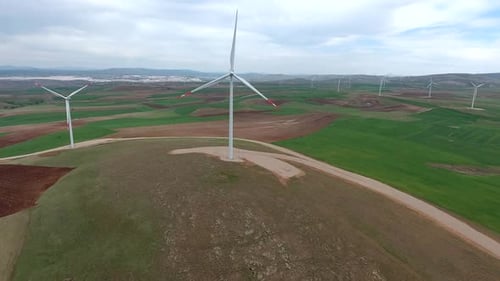 Wind Power Plant on Edge of Brown Treeless Fields in Vast Plain