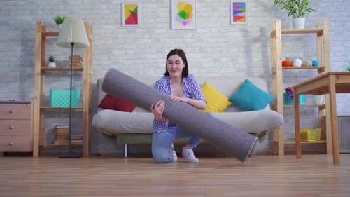 Young Woman Brings a New Carpet