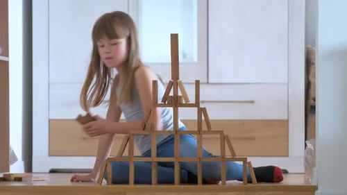 Creative Child Girl Playing with Game Stacking Wooden Toy Blocks in High Building Structure