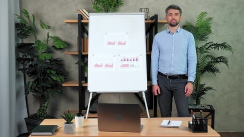 Man Presenting Business Charts in Office Setting