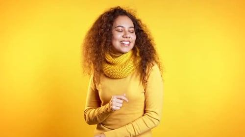 Young Cute Girl Dancing on Yellow Studio Background. Woman Colorful Bright Wear