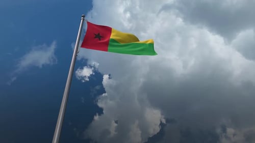 National Flag of Guinea-Bissau Waving Against Cloudy Sky