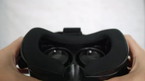 Hands Bring VR Headset into Dark View