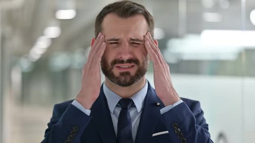 Business Man With Headache In Office