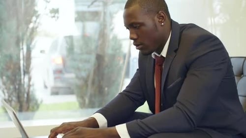 Black Businessman Working with Computer in Office