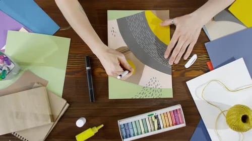 Artist Creating Abstract Design with Markers and Paper
