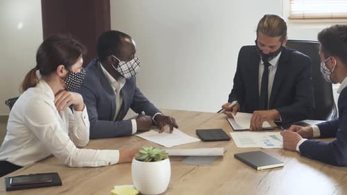 International Business Meeting Office Workers in Medical Masks Colleagues Discuss Working