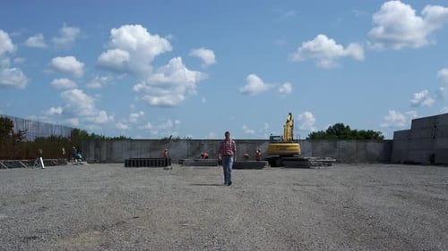 Adult Walking on Construction Site in Daytime