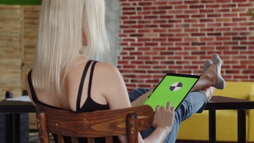 Woman Using Tablet with Green Screen in Home Office