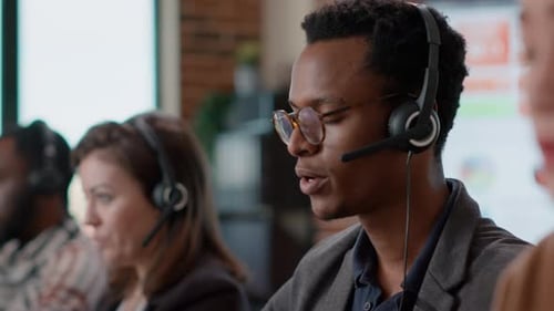 Man Talking with Headset in a Call Center