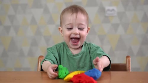 Joyful Toddler Playing with Colorful Modeling Clay