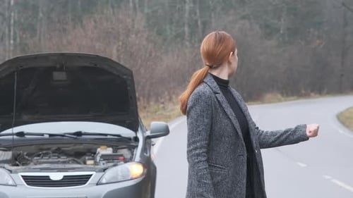 Woman at the Background of Broken Car in the Forest Trying Hitchhiking Other Cars