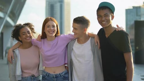 Smiling Friends Standing Arm in Arm Together