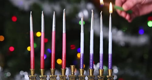 Lighting Hanukkah Candles on a Menorah