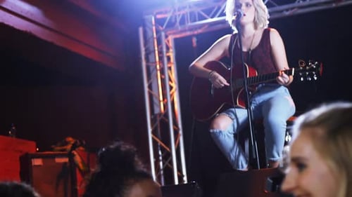 Singer Performing with Guitar at Intimate Music Venue