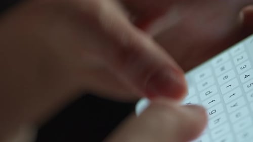 Close up view of hand typing on cellphone