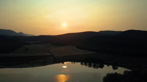 View of lake with field