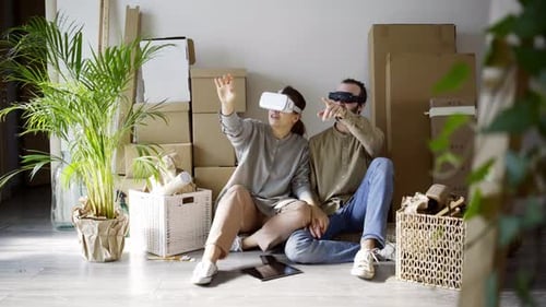 Young Couple Experiencing Virtual Reality in New Home