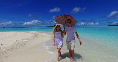 Young boy and girl on honeymoon vacation enjoy life on beach on clean white sand background