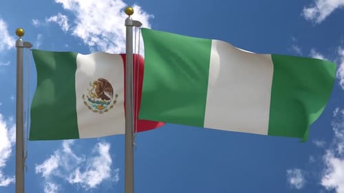Waving Flags of Mexico and Nigeria with Blue Sky Background