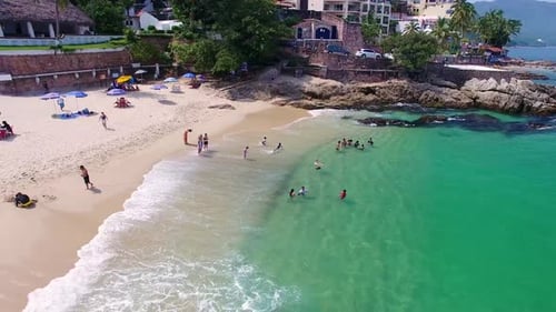 Tropical Beach with Swimmers and Sunbathers