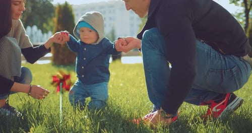 Family Plays Together in City Park on Sunny Day