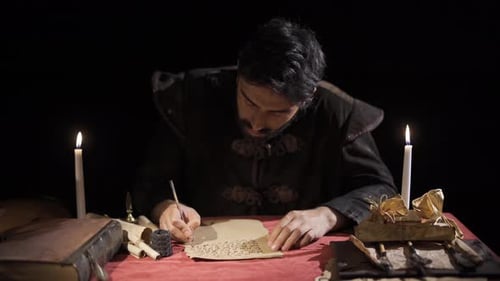 Man Writing Letter by Candlelight in Historical Setting