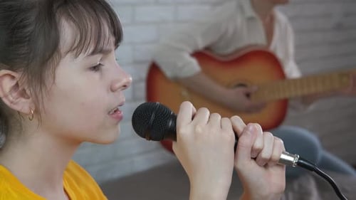 Girl Singing with Guitar Accompaniment at Home