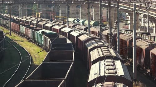 Freight Train Cars Curving on Tracks Aerial View