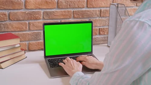 Unrecognizable Woman Typing on Laptop with Green Screen