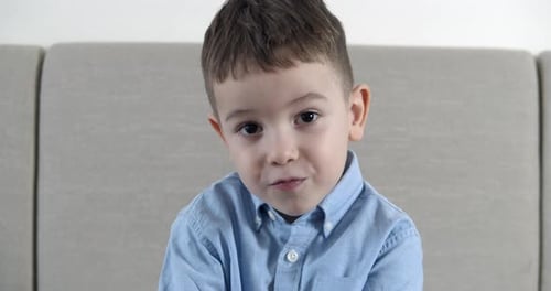 A Little Boy Opened His Mouth From What He Saw a Child Looks at the Camera with a Surprised Face