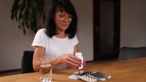 Woman Preparing Medication at Home with Pills