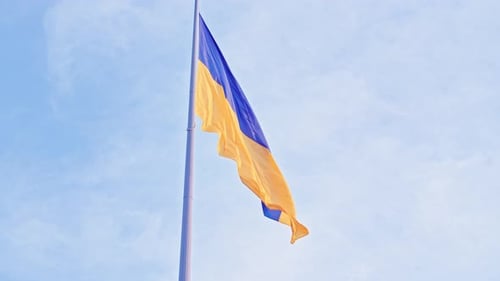 Ukrainian Flag Waving Against a Blue Sky