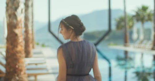 Young lady walking over the pool on holidays. Travel vacation woman relaxing