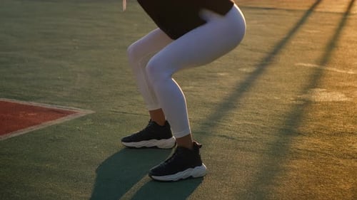 Woman Doing Squats at Golden Hour
