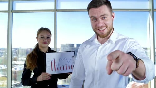 Business Colleagues Presenting a Chart Inside Modern Office